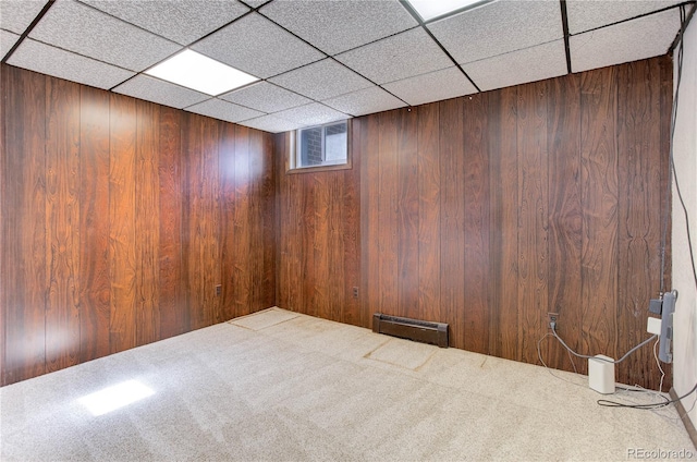 3561 Kalispell St, Aurora, CO 80011 - below grade area with baseboard heating, carpet flooring, wooden walls, and a drop ceiling