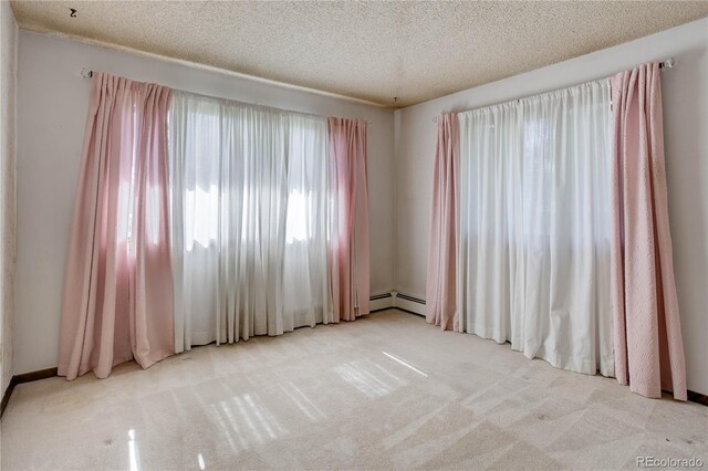3561 Kalispell St, Aurora, CO 80011 - carpeted empty room featuring a baseboard radiator and a textured ceiling