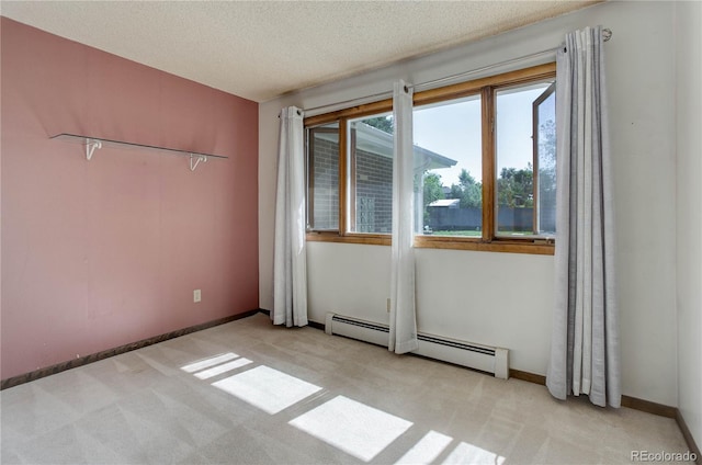 3561 Kalispell St, Aurora, CO 80011 - empty room with a baseboard heating unit, light carpet, and a textured ceiling