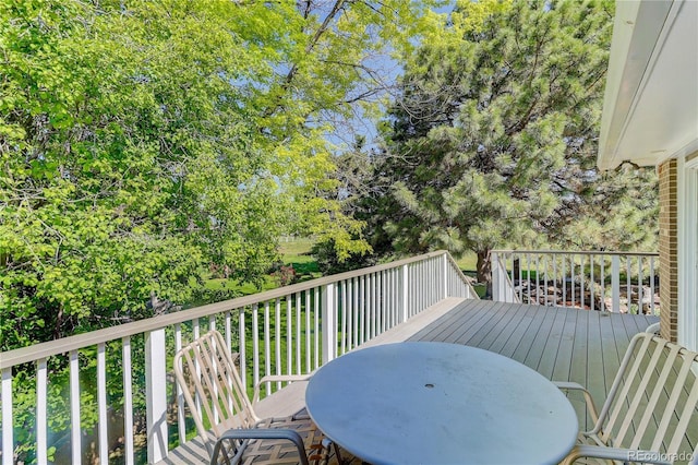 3561 Kalispell St, Aurora, CO 80011 - deck featuring outdoor dining area and view of scattered trees