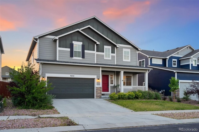 9632 Emerald Vista Dr, Peyton, CO 80831 - view of front of property with covered porch, board and batten siding, a garage, concrete driveway, and a front yard
