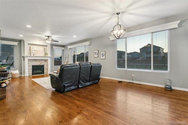 9632 Emerald Vista Dr, Peyton, CO 80831 - living area with a fireplace, wood finished floors, a chandelier, recessed lighting, and ceiling fan