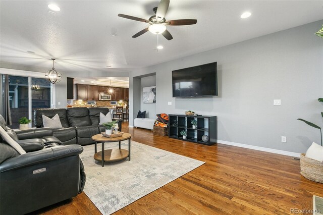 9632 Emerald Vista Dr, Peyton, CO 80831 - living room with a ceiling fan, wood finished floors, recessed lighting, and a chandelier