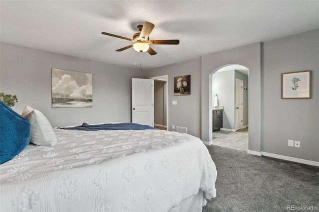 9632 Emerald Vista Dr, Peyton, CO 80831 - bedroom with arched walkways, carpet flooring, connected bathroom, and ceiling fan