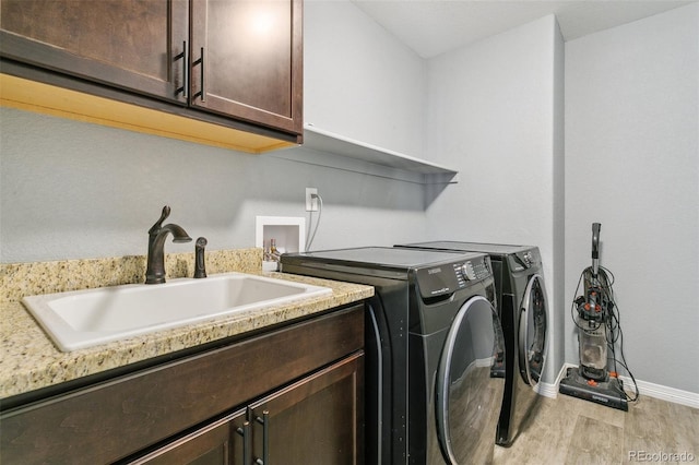 9632 Emerald Vista Dr, Peyton, CO 80831 - laundry area with cabinet space, washing machine and dryer, and light wood-style floors