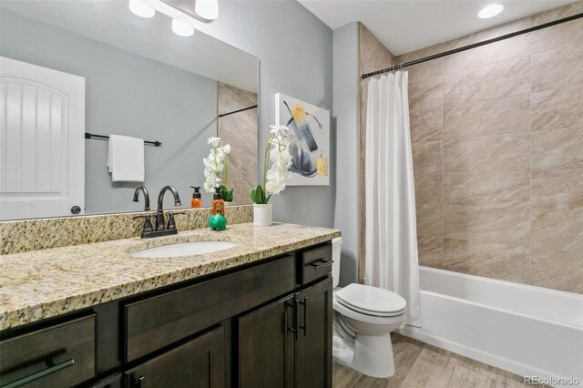9632 Emerald Vista Dr, Peyton, CO 80831 - full bath featuring vanity, wood finished floors, and shower / bath combination with curtain