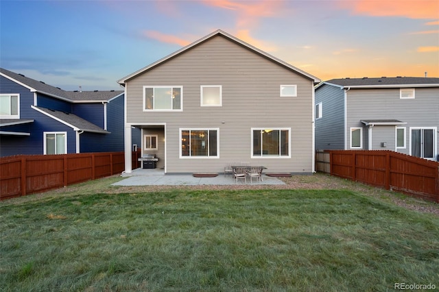 9632 Emerald Vista Dr, Peyton, CO 80831 - back of property at dusk with a fenced backyard and a patio area