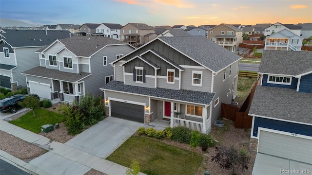 9632 Emerald Vista Dr, Peyton, CO 80831 - view of front facade featuring a porch, board and batten siding, a residential view, concrete driveway, and a garage