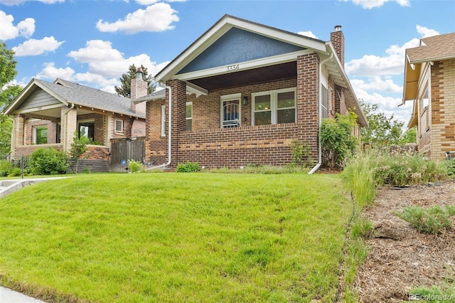 3334 W 37th Ave, Denver, CO 80211 - bungalow-style house with a chimney, brick siding, and a front yard