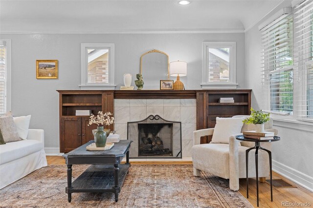 3334 W 37th Ave, Denver, CO 80211 - living area with wood finished floors, a tile fireplace, crown molding, baseboards, and recessed lighting