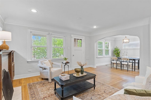 3334 W 37th Ave, Denver, CO 80211 - living room featuring arched walkways, baseboards, light wood-type flooring, recessed lighting, and ornamental molding