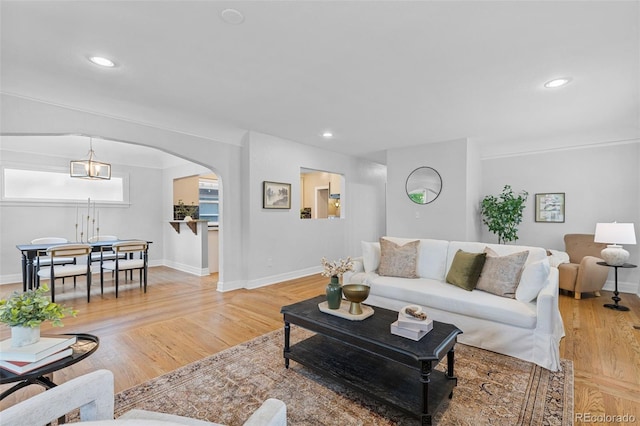 3334 W 37th Ave, Denver, CO 80211 - living area with arched walkways, baseboards, recessed lighting, and light wood finished floors
