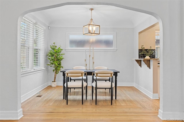 3334 W 37th Ave, Denver, CO 80211 - dining room featuring arched walkways, healthy amount of natural light, baseboards, and crown molding