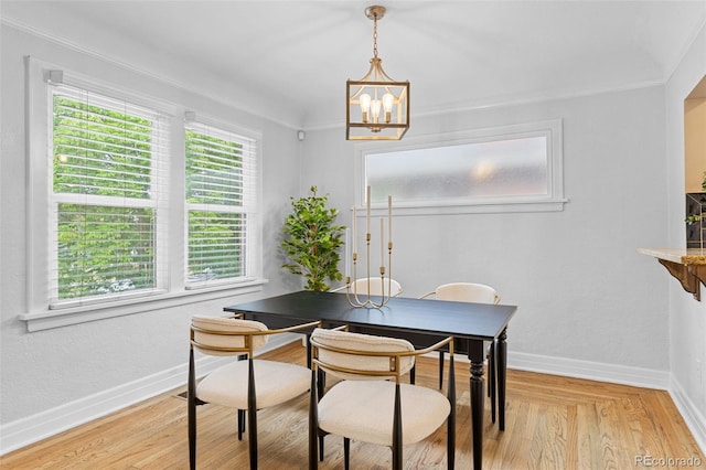 3334 W 37th Ave, Denver, CO 80211 - dining area featuring a chandelier, baseboards, and crown molding