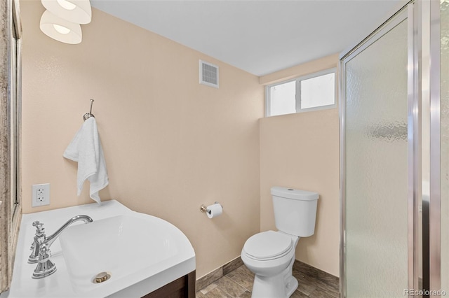 3334 W 37th Ave, Denver, CO 80211 - bathroom featuring a stall shower, toilet, baseboards, and vanity