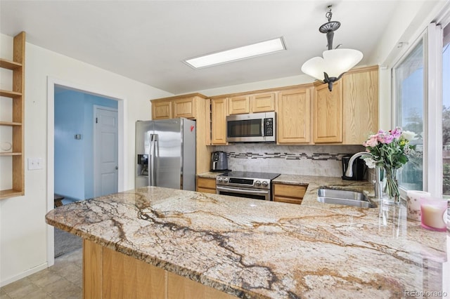 7075 Welch Ct, Arvada, CO 80004 - kitchen with stainless steel appliances, a sink, decorative backsplash, a peninsula, and light stone countertops
