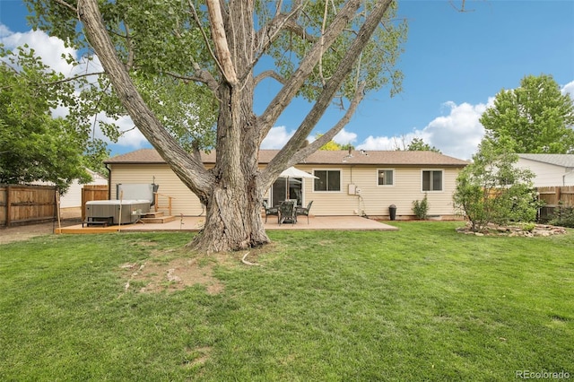 7075 Welch Ct, Arvada, CO 80004 - rear view of house with a hot tub and a patio
