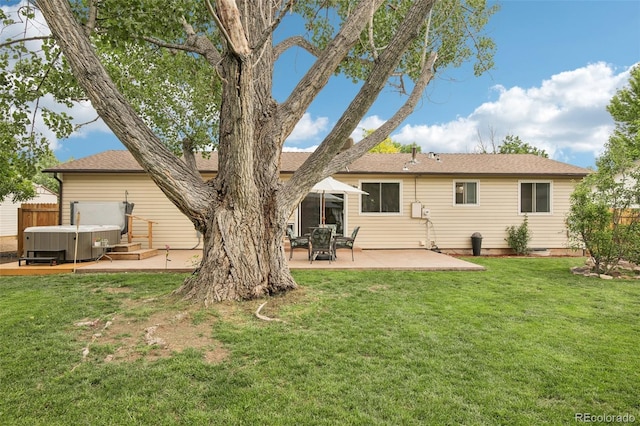 7075 Welch Ct, Arvada, CO 80004 - rear view of property with a hot tub, a patio area, and a shingled roof