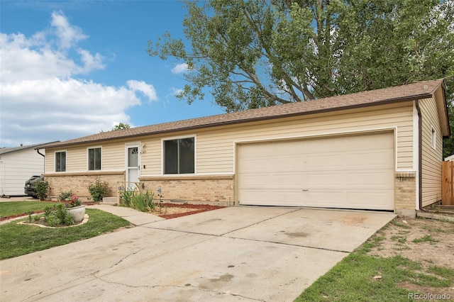 7075 Welch Ct, Arvada, CO 80004 - ranch-style house featuring brick siding, driveway, and a garage