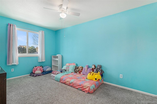 carpeted bedroom featuring a textured ceiling and ceiling fan