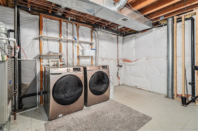 clothes washing area with independent washer and dryer