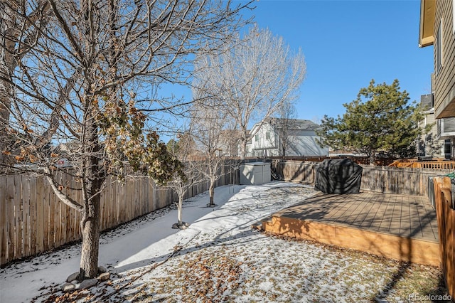 snowy yard with a deck