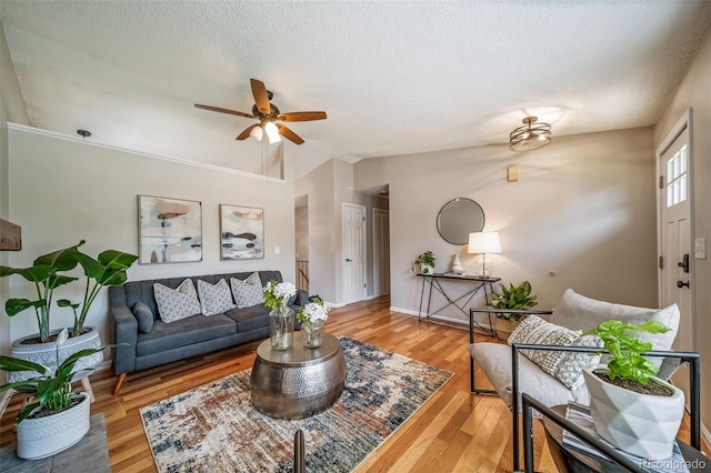18159 E Crestline Cir, Centennial, CO 80015 - living room featuring ceiling fan, lofted ceiling, a textured ceiling, and wood finished floors