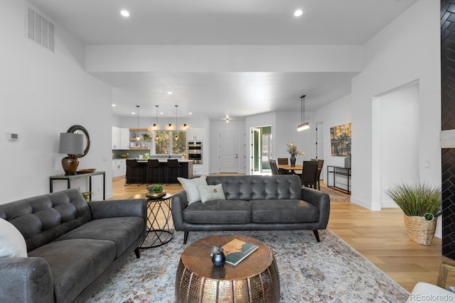 living room with a wealth of natural light and light hardwood / wood-style floors