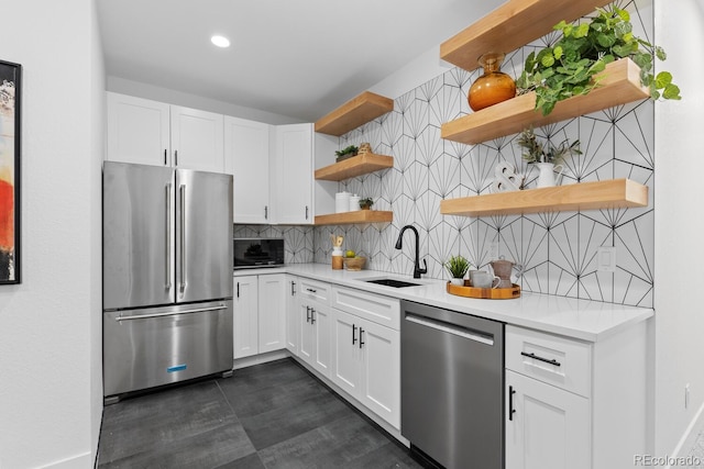 kitchen featuring tasteful backsplash, stainless steel appliances, sink, and white cabinets