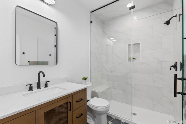 bathroom featuring walk in shower, vanity, and toilet