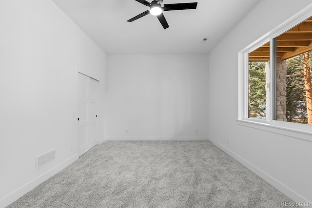 spare room featuring ceiling fan and carpet