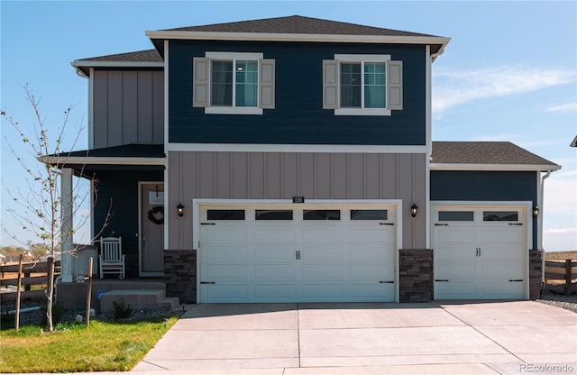 236 Racer St, Bennett, CO 80102 - view of front facade with concrete driveway, board and batten siding, stone siding, and fence