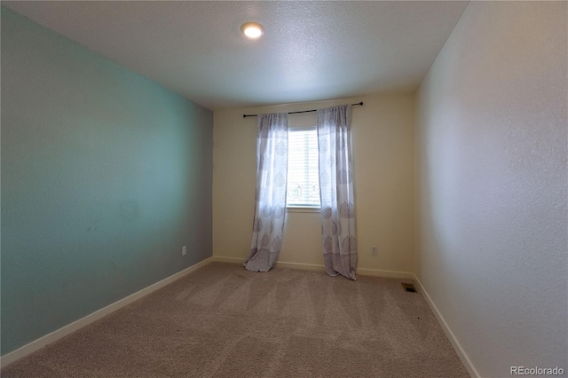 236 Racer St, Bennett, CO 80102 - unfurnished room featuring carpet floors, baseboards, visible vents, and a textured ceiling