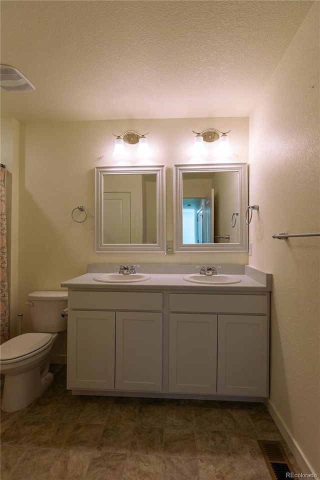 236 Racer St, Bennett, CO 80102 - full bath with a sink, visible vents, toilet, and double vanity