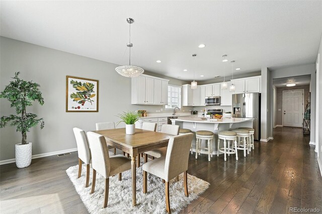 12554 Hudson Ct, Thornton, CO 80241 - dining room featuring dark wood finished floors and recessed lighting