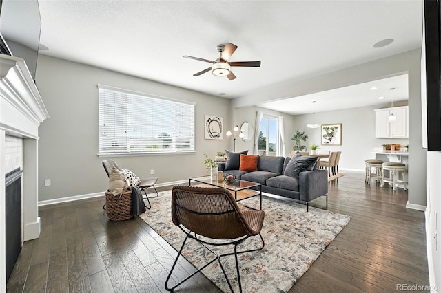 12554 Hudson Ct, Thornton, CO 80241 - living room featuring ceiling fan, dark wood-type flooring, and a fireplace