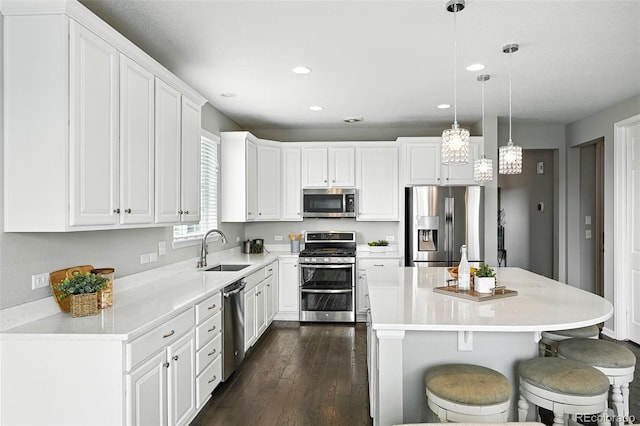 12554 Hudson Ct, Thornton, CO 80241 - kitchen with appliances with stainless steel finishes, recessed lighting, white cabinets, dark wood-type flooring, and light countertops