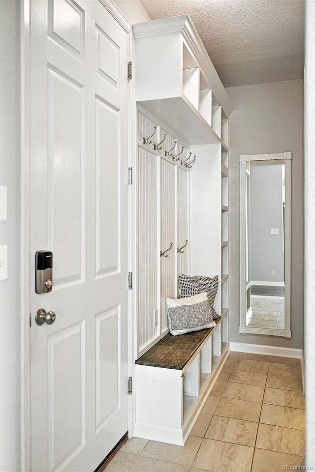 12554 Hudson Ct, Thornton, CO 80241 - mudroom featuring a textured ceiling and light tile patterned floors