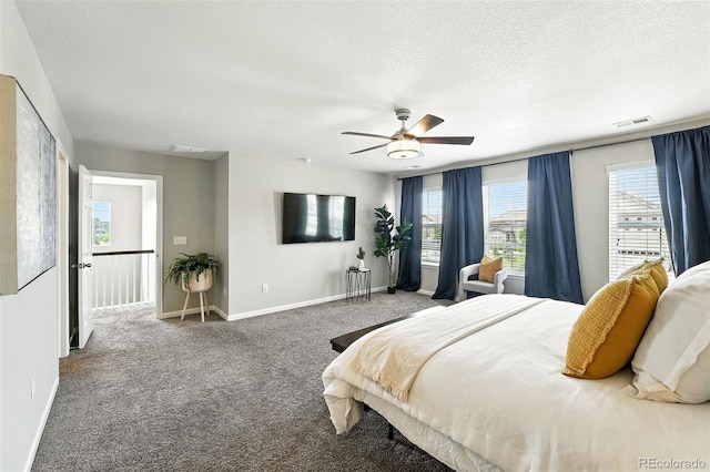 12554 Hudson Ct, Thornton, CO 80241 - carpeted bedroom featuring multiple windows, a textured ceiling, and a ceiling fan