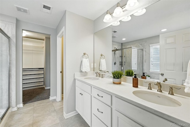 12554 Hudson Ct, Thornton, CO 80241 - bathroom with a stall shower, a walk in closet, double vanity, and tile patterned floors