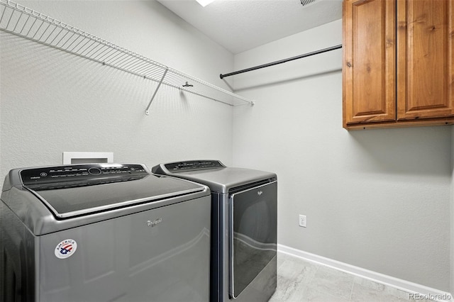 12554 Hudson Ct, Thornton, CO 80241 - laundry area featuring cabinet space and washing machine and dryer