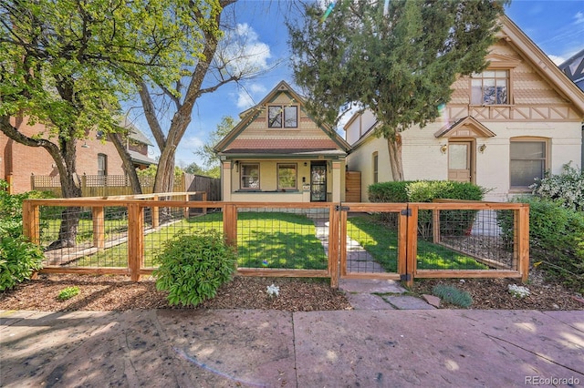 view of front of property with a gate, a fenced front yard, a porch, and a front lawn