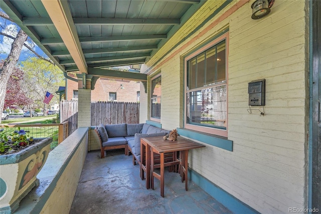 view of patio / terrace with fence and covered porch