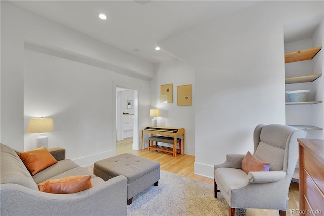 living area with recessed lighting, light wood-style flooring, and baseboards