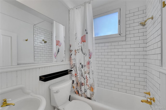 full bathroom featuring shower / bath combo with shower curtain and toilet