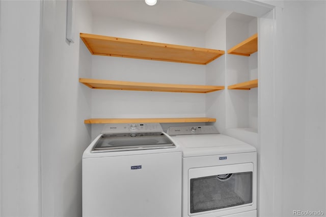 washroom featuring laundry area and washing machine and clothes dryer