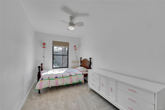 carpeted bedroom featuring baseboards and ceiling fan