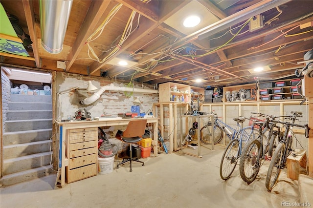unfinished basement featuring a workshop area