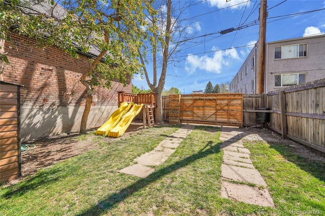 view of yard featuring a fenced backyard and a playground