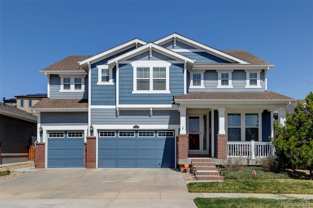 craftsman inspired home with a garage, covered porch, brick siding, a shingled roof, and concrete driveway